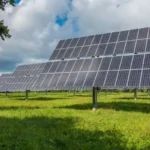 Painéis solares em um campo aberto, ilustrando como investir em energia solar vale a pena e proporciona economia com energia solar a longo prazo.